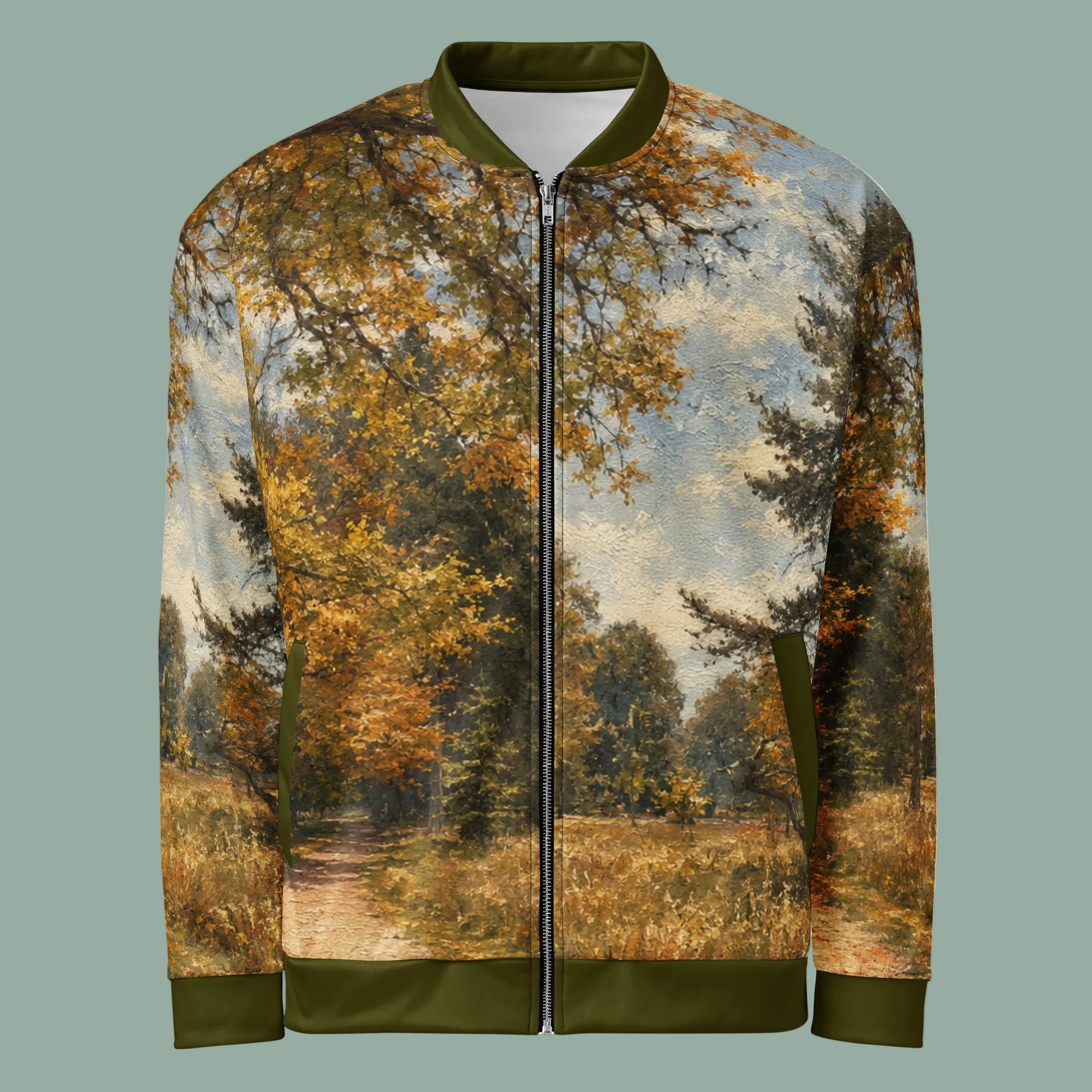 A zip-front bomber jacket with an all-over landscape print of an autumn forest path, featuring olive green ribbed collar, cuffs, and hem, shown on a plain white background.