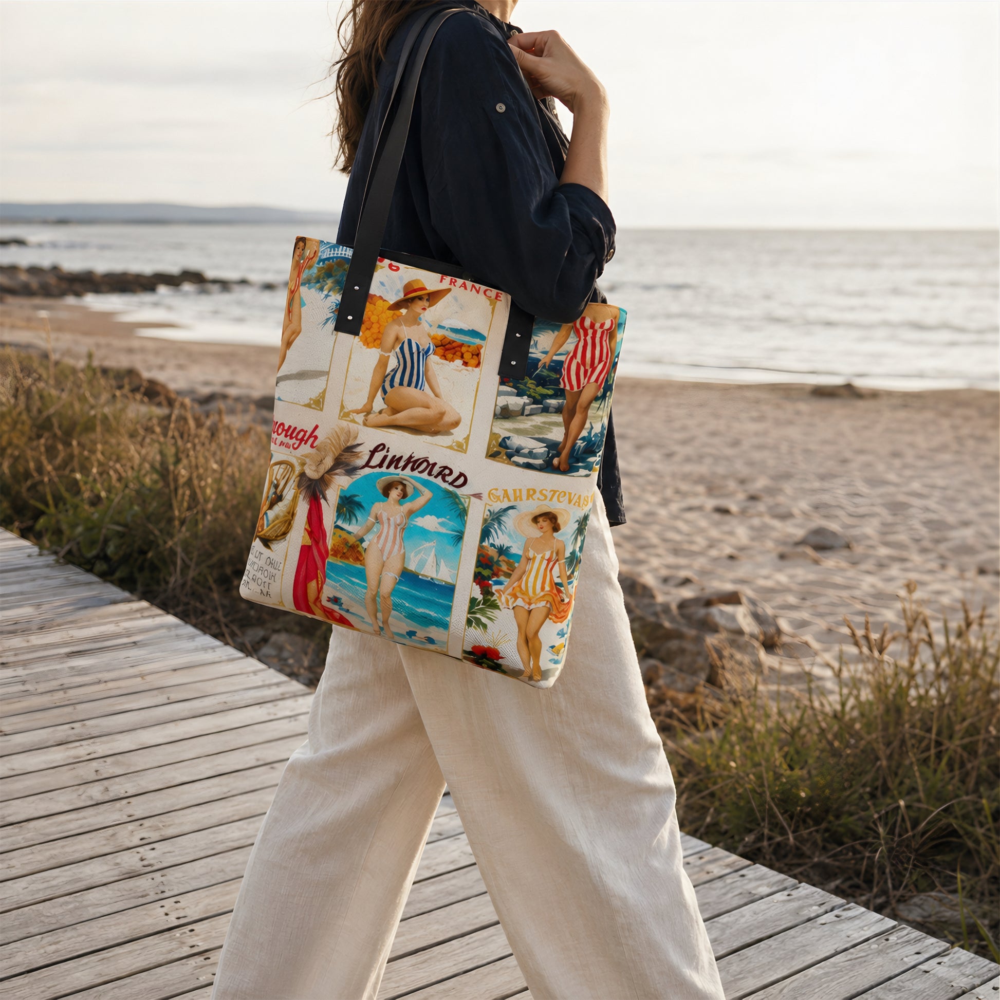 A woman walking on a wooden boardwalk by the beach carries a large tote bag printed with vintage seaside resort illustrations. The bag has a cream base with multicolored beach scenes and text including 'Cinque Terre' and 'Sorrento'.