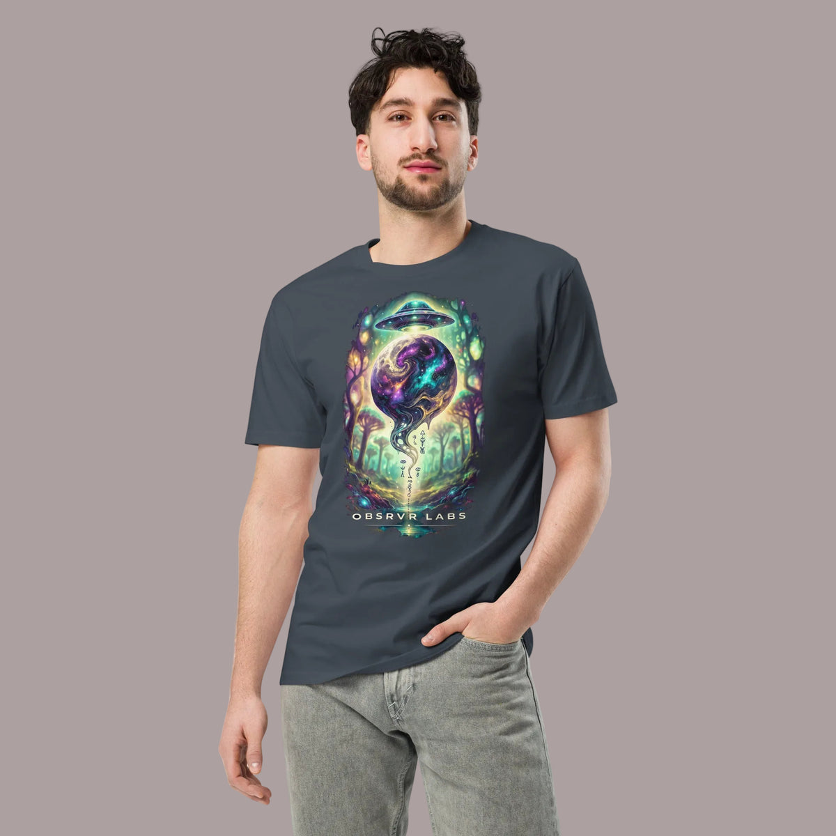 A man wearing a dark gray crewneck t-shirt with a colorful cosmic graphic on the front that reads 'OBSERVE LABS'. The background is solid white.